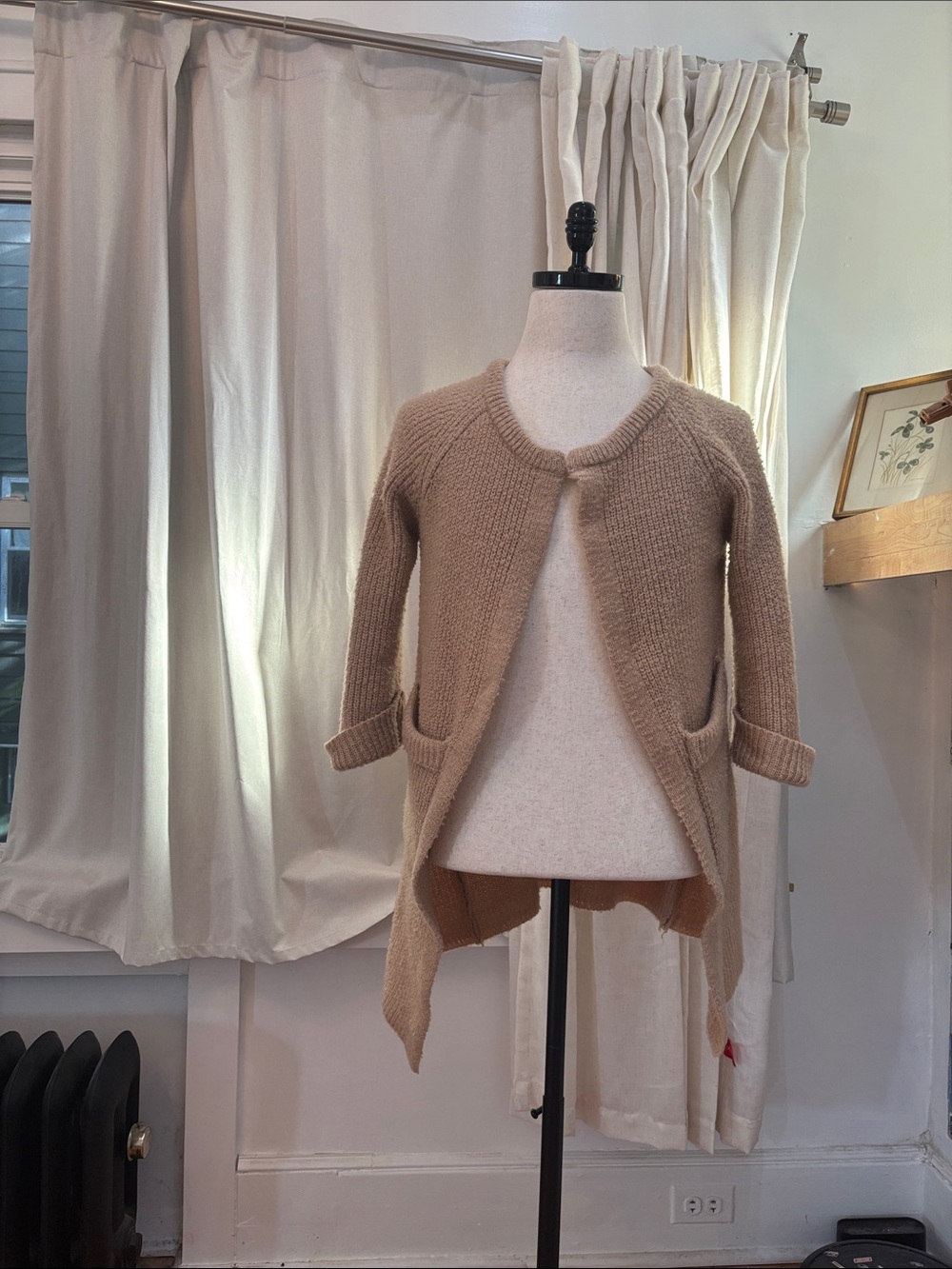 A light brown cardigan made out of cotton